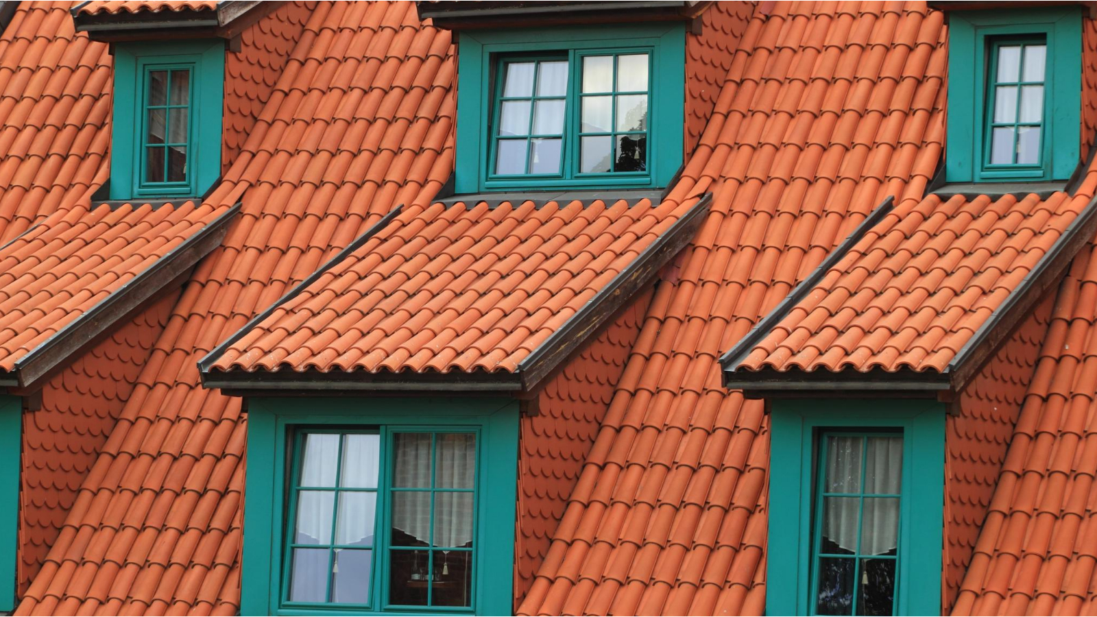 green color house with bright orange shingles