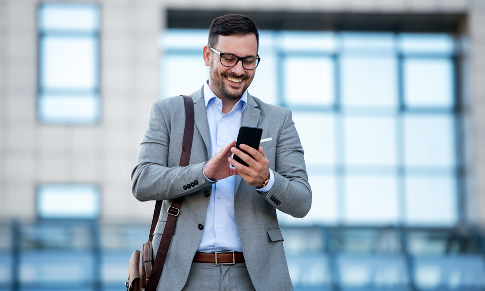 a man very pleased to see a responsive website on his mobile